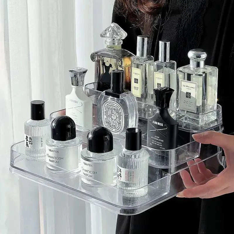 Bathroom shelf makeup organizer clear tiered tray holding various perfume bottles and skincare products for bathroom storage and organization